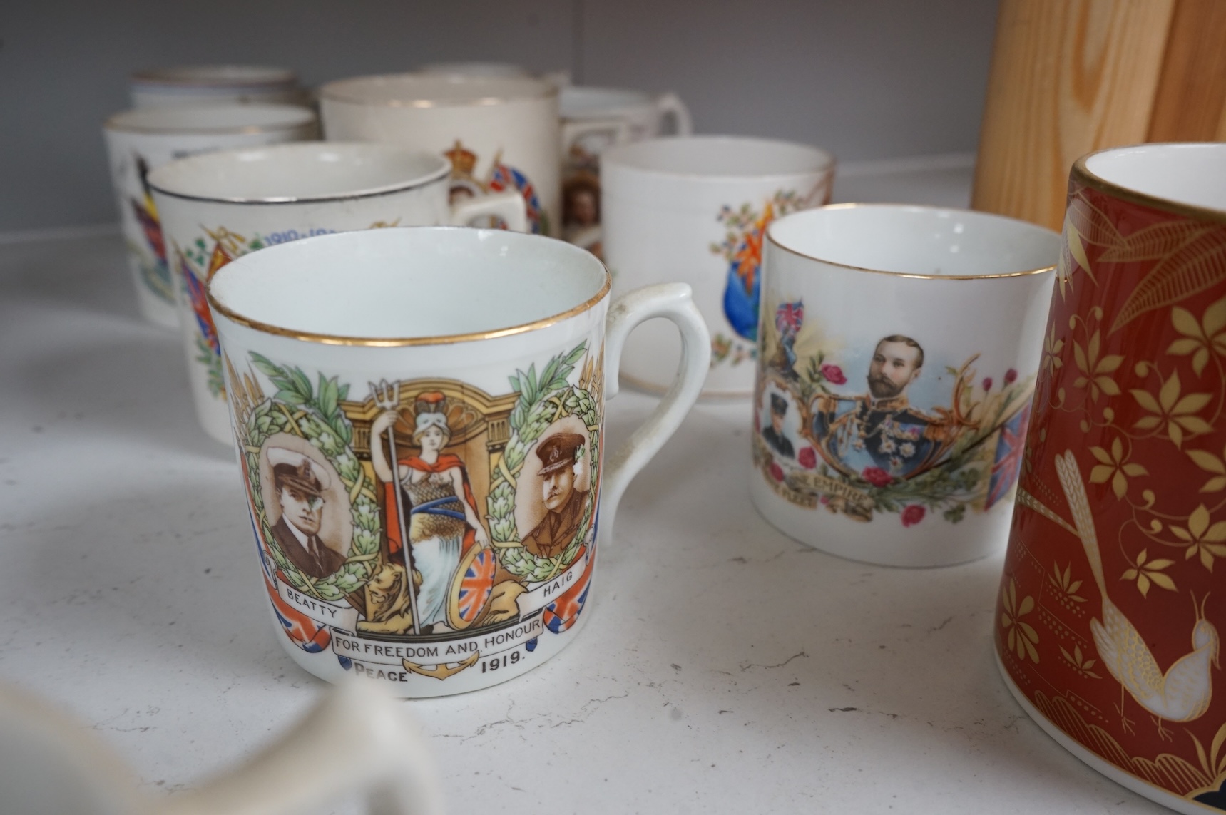 A lithophane commemorative mug and ten others to include George VI and Elizabeth coronation 1937, largest 9.5cm high